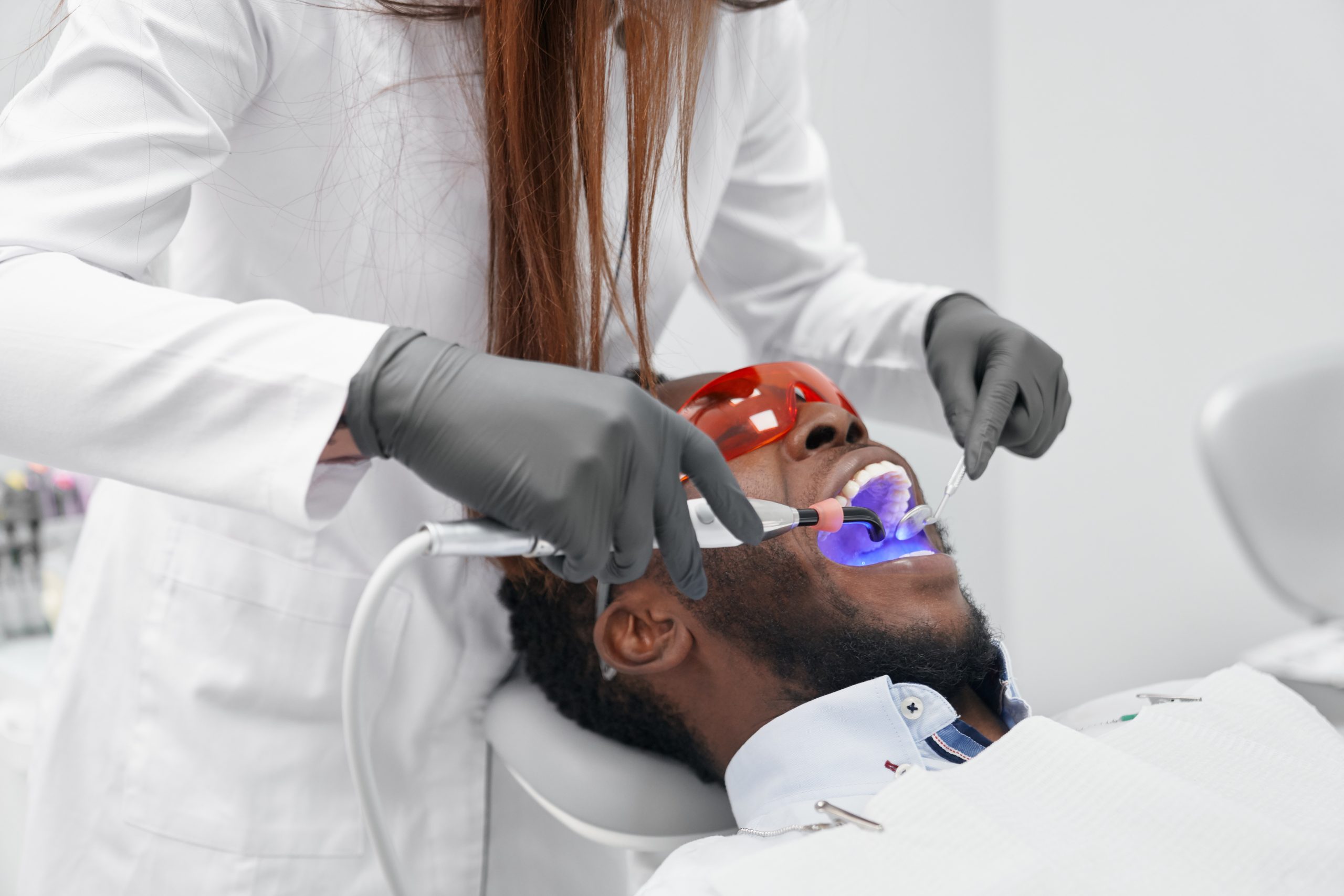 Dental professional providing treatment to a patient